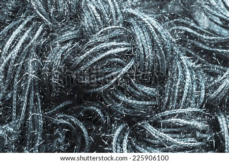 Weaving silver metallic threads closeup as a background