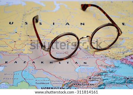 Glasses on a map of Asia - Astana