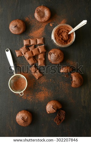 Homemade chocolate muffins on dark wooden background