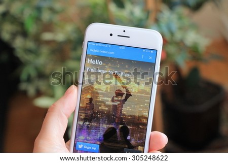 SARAJEVO , BOSNIA AND HERZEGOVINA - AUGUST 02 , 2015: Woman watch Twitter icons on Apple iPhone 6. Twitter is largest and most popular social networking site in the world.