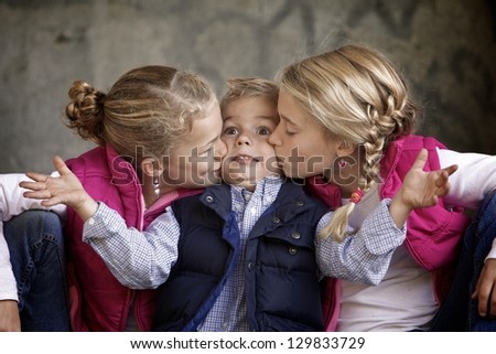 Silly siblings together with brother getting kissed