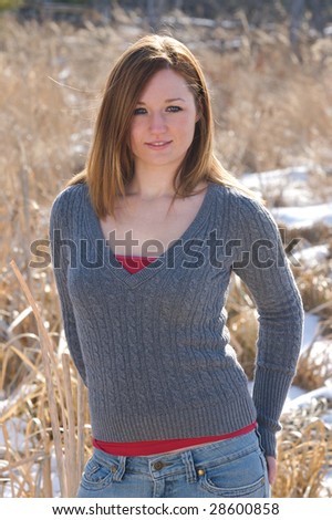 Young red headed woman with sweater outside in winter