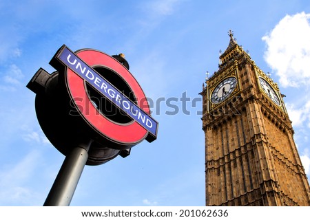 LONDON, UK - APRIL 23, 2014: View of London Underground subway sign in front of famous Clock Tower (now officially called the Elizabeth Tower) with bell Big Ben at Westminster in London.