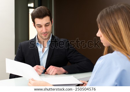 young doctor speaking with client and show him medical information : they discussing together on medical exam at hospital