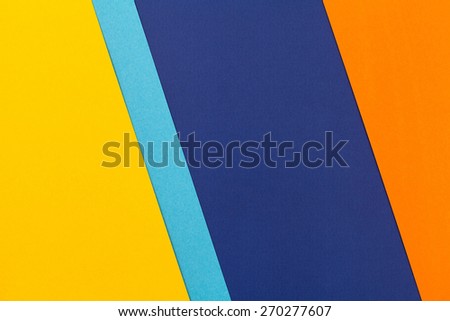 Color papers geometry flat composition background with yellow blue and oranges tones