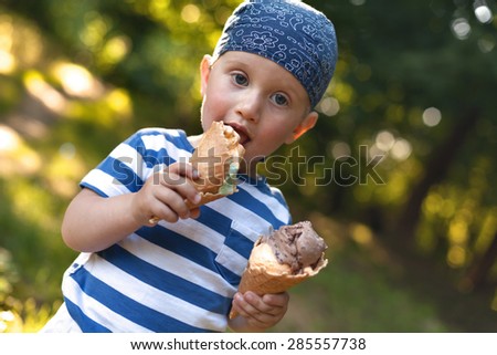 Boy eating ice-cream and playing with his mom