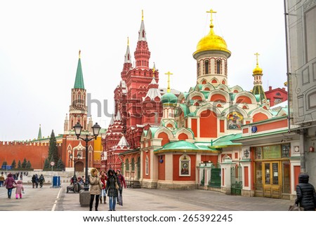 MOSCOW - MARCH 22: Red Square view from Nikolskaya street. Kazan cathedral, Historical museum and Nikolskaya tower of the Kremlin wall, People walking on the street in March 22, 2015.