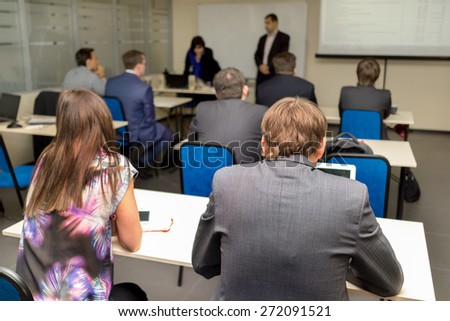 The audience listens to the acting in a classroom