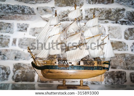 BUDVA, MONTENEGRO - SEPTEMBER 5, 2015: Wooden replica of the old vessel sailfish as ship model in a stone room inside the old town.