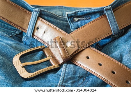Leather belt on  jeans pants background