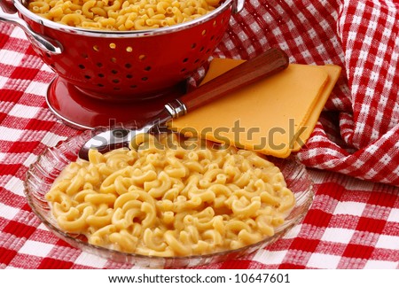 macaroni and cheese with red strainer and red checked material