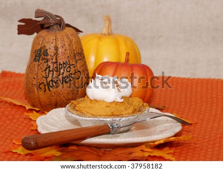 Mini pumpkin mouse with decorative pumpkins on a plate with a fork