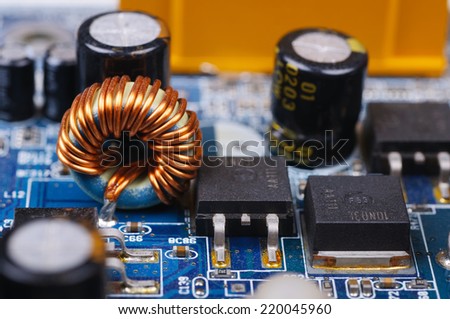 Part of PC main board with electronic components. Closeup with shallow DOF.