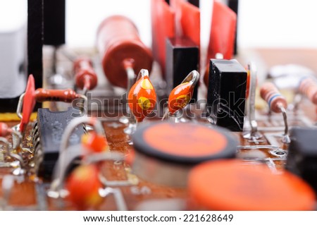 Part of old vintage printed circuit board with electronic components. Closeup with shallow DOF.
