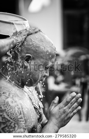 NONTHABURI, THAILAND - MAY 03 : Thai man With a tattoo on the arm during a Buddhist ordination ceremony. Father hand poured water over his head on May 03, 2015 in Nonthaburi, Thailand. black and white