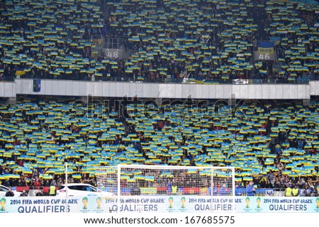KIEV, UKRAINE - NOV 15: Fans of the Ukrainian team in the stands with the flag during the play-off match for the 2014 World Cup, 15 November 2013, NSC Olympic Stadium, Kiev, Ukraine