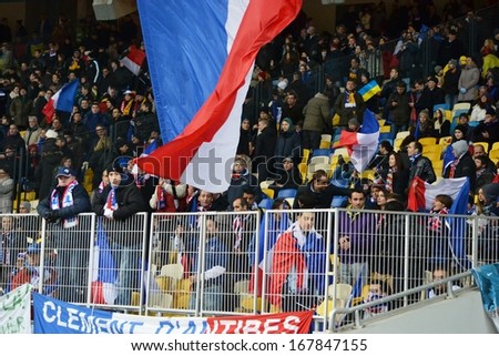 KIEV, UKRAINE - NOV 15: French football fans with flag in the stands during the play-off match for the 2014 World Cup between Ukraine vs France, 15 November 2013, NSC Olympic Stadium, Kiev, Ukraine
