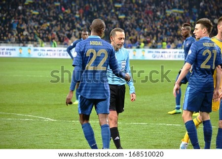 KIEV, UKRAINE - NOV 15: Laurent Koscielny (R) and Eric Abidal (L) communicate with the referee during the play-off match for the 2014 World Cup, 15 November 2013, NSC Olympic Stadium, Kiev, Ukraine