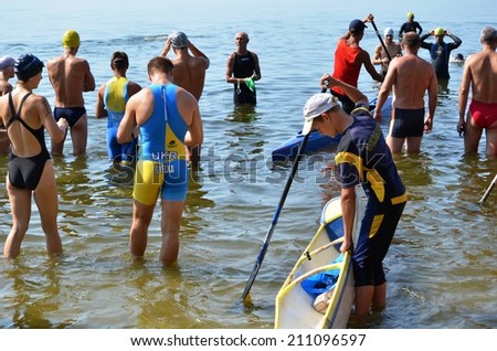CHERKASSY, UKRAINE - AUG 8: Swimmers start rowing during VI International swim across the Dnieper River, 10 km, 8 August 2014, Cherkassy, Ukraine