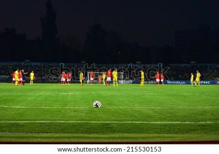CHERKASSY, UKRAINE - SEP 4: Football ball in the corner of the gate on the background of the players during the qualifying match national teams, 4 September 2014, Cherkassy, Ukraine