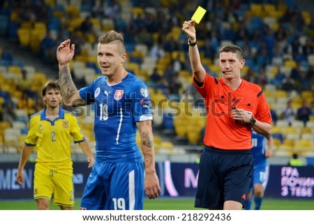 KIEV, UKRAINE - SEP 8: Juraj Kucka receives a yellow card from the referee during the match Ukraine 0-1 Slovakia UEFA Euro 2016 qualifier match, 8 September 2014, Kiev, Ukraine