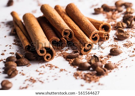Close up of cinnamon sticks, coffe beans and particles of chocolate