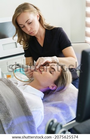 Woman client during deep facial cleansing in a cosmetology clinic Foto stock © 