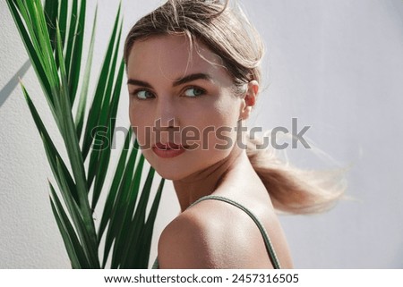 Similar – Image, Stock Photo Model with leaf shadows on face in light ray