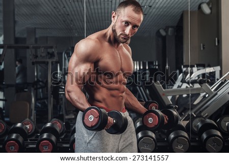 Young and muscular man doing a exercise for biceps