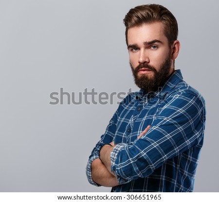 Portrait of handsome bearded man in checkered shirt