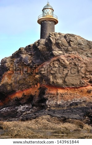 Old stone lighthouse on the Cliff of colors in tip of Jandia, coast of  Fuerteventura, Canary islands, Spain