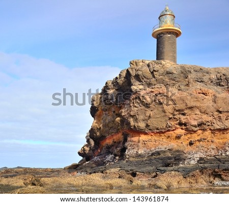 Stone lighthouse on the crag in tip of Jandia, coast of Fuerteventura, Canary islands, Spain