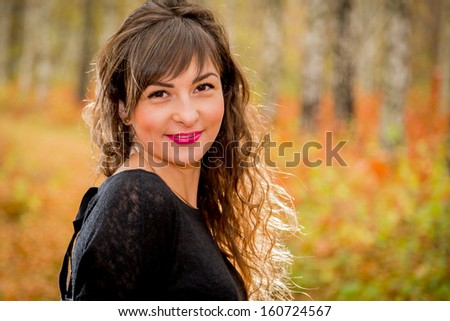 Charming lady posing on autumn background