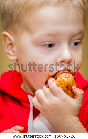 little beautiful boy eating cookies