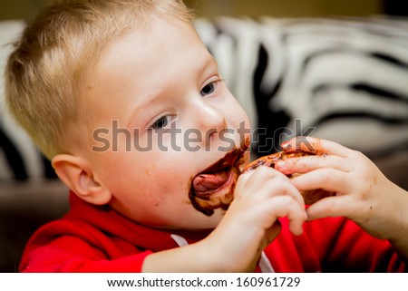 little beautiful boy eating cookies