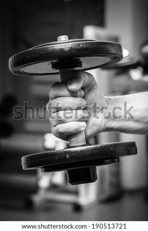 the hand with the dumbbell