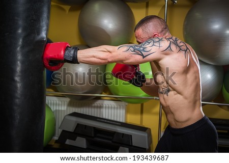 man with tatoo boxing