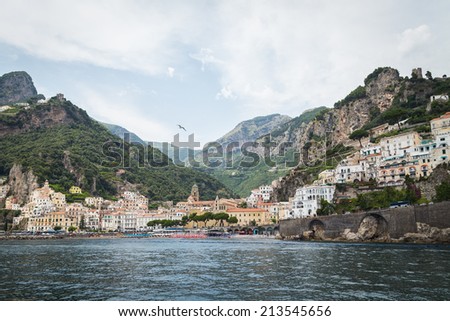 Beautiful town seascape. View of the beautiful city with colorful houses and boats. City, sea, landscape, Italy, Amalfi. Use in articles about Italy and marine leisure.