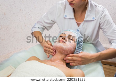 ?osmetic procedures in spa clinic.Beautician performs cosmetic procedures.applying cosmetic cream. Cosmetology, facial, beauty - The concept of facial skin care. Article about cosmetology.