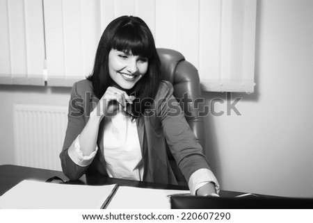 Successful business woman looking confident and smiling.Young pretty business woman with notebook in the office/Candid image of a businesswoman working in a cafe.