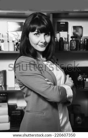 Successful business woman looking confident and smiling.Young pretty business woman with notebook in the office/Candid image of a businesswoman working in a cafe.