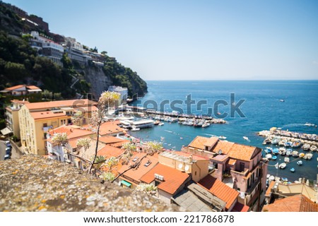 A beautiful landscape. Overlooking the beautiful seaside town in the Mediterranean. Houses with red roofs, blue sea, day. Use for cards and backgrounds on coastal towns.