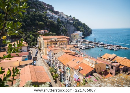 A beautiful landscape. Overlooking the beautiful seaside town in the Mediterranean. Houses with red roofs, blue sea, day. Use for cards and backgrounds on coastal towns.