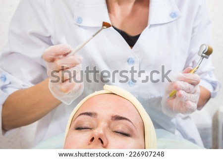 Medical cosmetic procedure. Mikronidling. Beautician performs Dermaroller procedure.young beautiful woman having an injection mesotherapy.osmetic procedures in spa clinic.