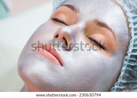 Pretty woman receiving facial treatment. Cosmetology, facial, beauty - The concept of facial skin care. Article about cosmetology.