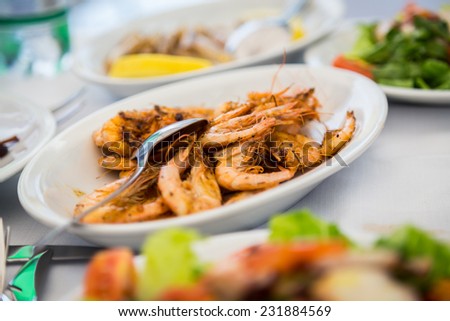 Plate with seafood. Appetizing dish with cooked shrimp. Delicious protein meal. Shrimp, seafood, herbs, Italian cuisine.