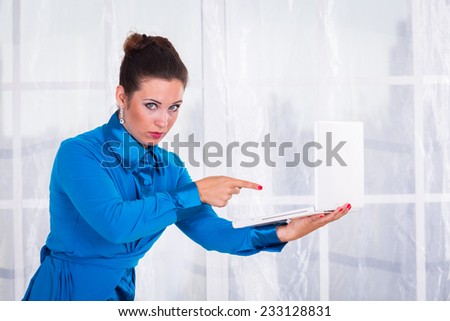 Business woman working in the office at the table.young business woman working at the computer on office background.Portrait of businesswoman with laptop.
