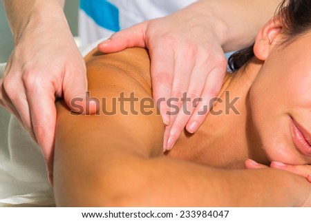 Beautiful young woman relaxing with hand massage at beauty spa. Masseur doing massage on woman body in the spa salon. Beauty treatment concept. Attractive Woman Having Massage With Massage Oil In Spa