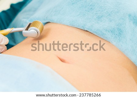 Cosmetic injection in the spa salon. Beautician makes injection into the patient\'s belly. the concept of rejuvenation.