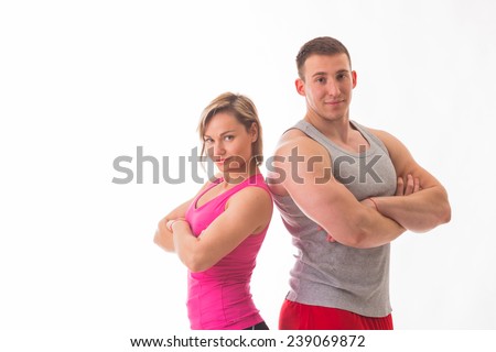Sports man and woman posing on a white background. Athletic couple in sportswear. Fitness, sports, good shape, the pair - the concept of family fitness.